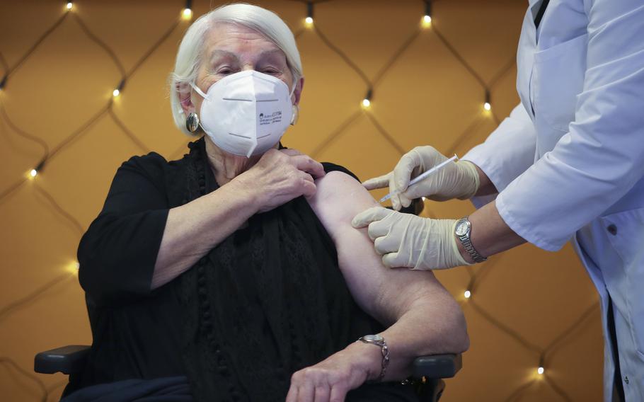 Gertrud Vogel, 92, receives the Pfizer/BioNTech vaccine from Dr. Irene Spiertz-Schmidt at a nursing home in Cologne, Germany, last December. A year later, European nations are trying various ways to stop the rapid new surge of COVID-19. 