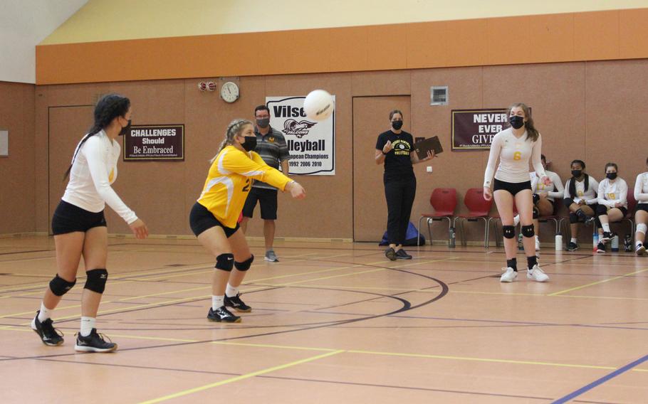 Stuttgart volleyball player McKenzie Maune lines up a pass alongside teammates Jazelyn Campbell, left, and Sofia Gentile.