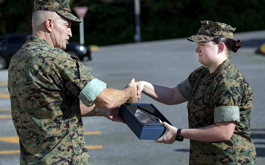 Lance Cpl. Noelle Gallegos, a patrolman with Marine Corps Installations Pacific's provost marshal’s office, receives the Jim Kallstrom Award for bravery from MCIPAC commander Brig. Gen. William Bowers at Camp Foster, Okinawa, Nov. 3, 2021.