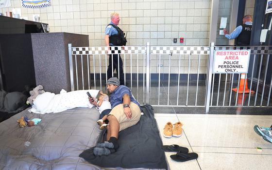 A migrant father from Venezuela entertains his 17-month-old daughter in the lobby of a police station where they have been staying with other migrant families since their arrival to the city on May 9, 2023, in Chicago, Illinois. (Scott Olson/Getty Images/TNS)