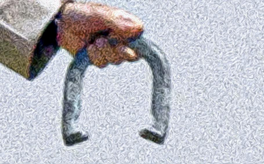 A photo illustration of a horseshoe being held during a competition.