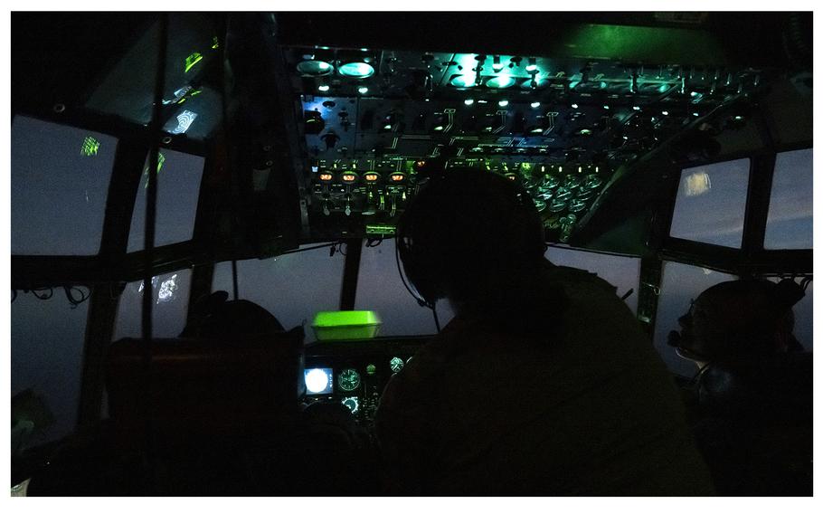 Crewmembers aboard a U.S. Air Force C-130H Hercules cargo aircraft fly above East Africa during a mission to deliver supplies to Somalia, on Jan. 2, 2024. According to reports on Saturday, Jan. 13, search and rescue efforts are underway off the coast of Somalia for two Navy SEALs who were discovered missing.