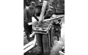 Muenster, Germany, November 1990: Pvt. Dondi Holsey and Spec. Tom Cicione of the 184th Ordnance Company at Muenster Army Depot cut lumber to be used as shipping braces for 155mm howitzer ammunition on its way to the Middle East during Operation Desert Shield.