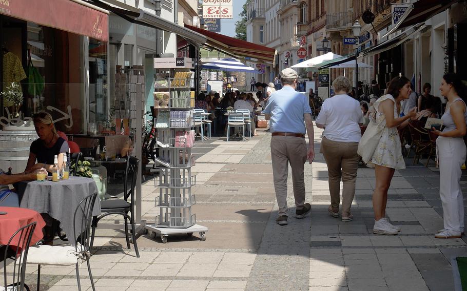 People shop on a pedestrian zone in Eltville.