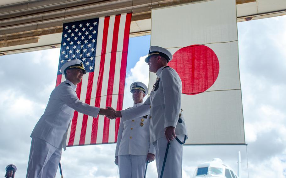 Capt. Manning Montagnet, right, outgoing commander of Naval Air Facility Atsugi, Japan, shakes hands with his replacement, Capt. Nicolas Leclerc, Thursday, Aug. 24, 2023. 