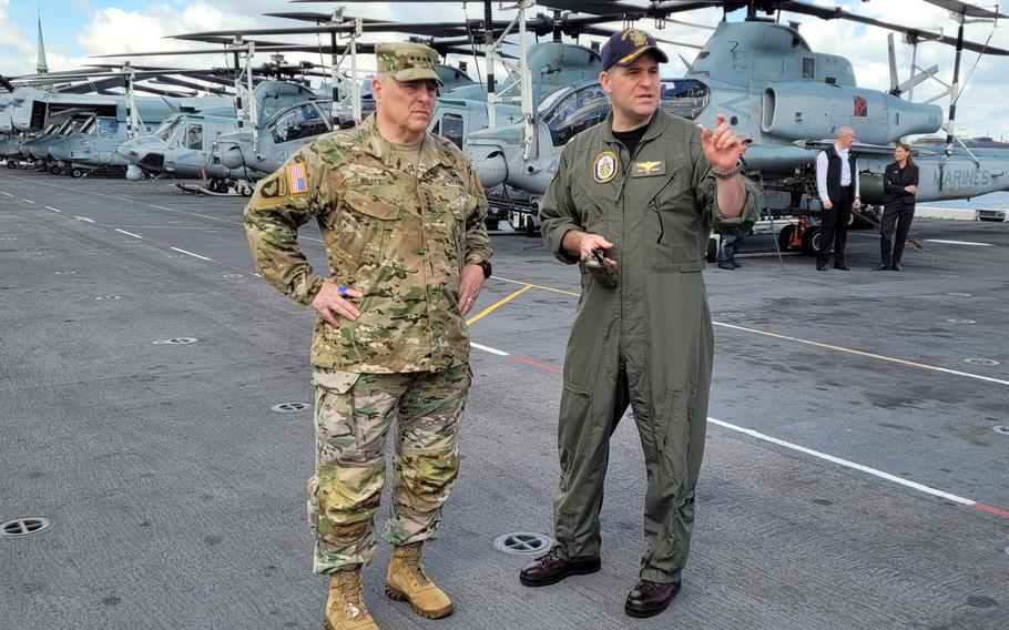 Gen. Mark Milley, chairman of the Joint Chiefs of Staff, meets with Navy Capt. Tom Foster, the commanding officer of the USS Kearsarge, aboard the vessel on June 4, 2022. 