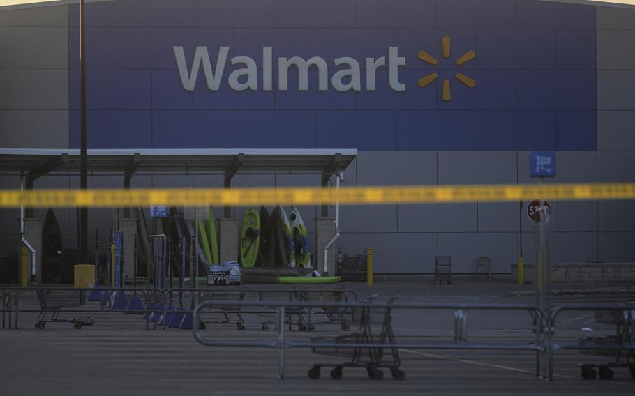 Police tape stretched across the parking lot of a Walmart.