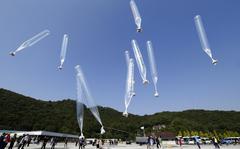 FILE - North Koran defectors release balloons carrying leaflets condemning North Korean leader Kim Jong Un and his government's policies, in Paju, near the border with North Korea, South Korea on  Oct. 10, 2014. North Korea suggested Friday, July 1, 2022 its COVID-19 outbreak began in people who had contact with balloons flown from South Korea, a highly questionable claim that appeared to be an attempt to hold its rival responsible amid increasing tensions. (AP Photo/Ahn Young-joon, File)