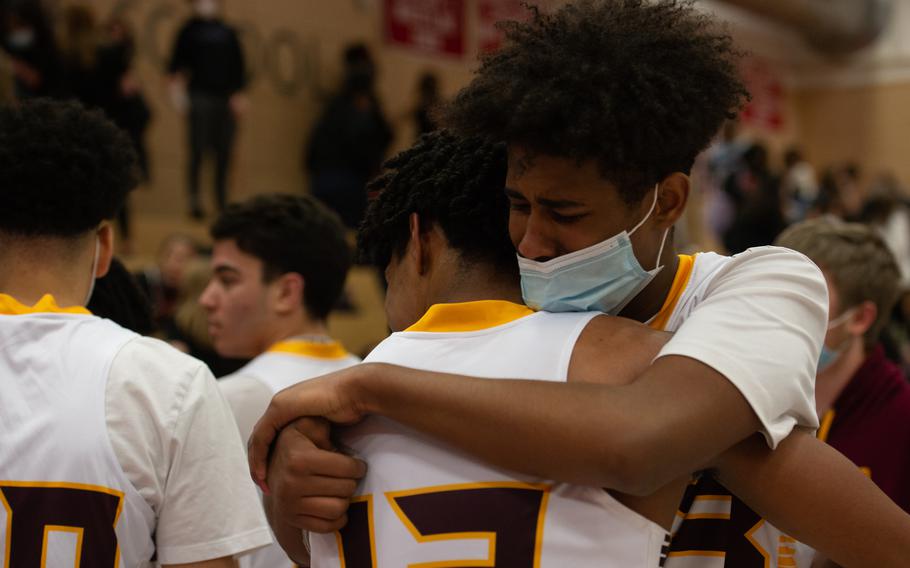 Baumholder's Jalen and Jovan Velasquez share a hug after their team's win at the DODEA-Europe Division III boys basketball title game in Kaiserslautern, Germany, on Saturday, Feb. 26, 2022.