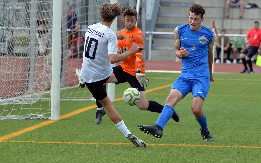 Ramstein keeper Everett Majer stops a shot by Stuttgart’s Andrew Wagner, as teammate Shane Monson helps out in the Royals’ 1-0 victory in the boys Division I final at the DODEA-Europe soccer championships in Kaiserslautern, Germany, Thursday, May 19 2022. 