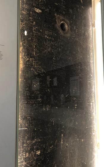 A steel door that was used to lock prisoners in cells is exhibited at the Hotel Silber museum in Stuttgart. The door is covered in scratch marks made by prisoners held during the Nazi period.