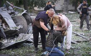 Residents react after a Russian missile hit a multi-storey apartment.