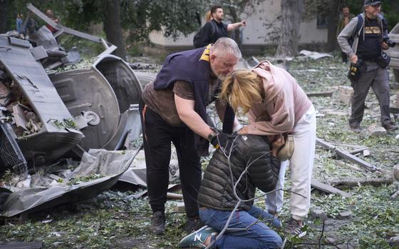 Residents react after a Russian missile hit a multi-storey apartment.