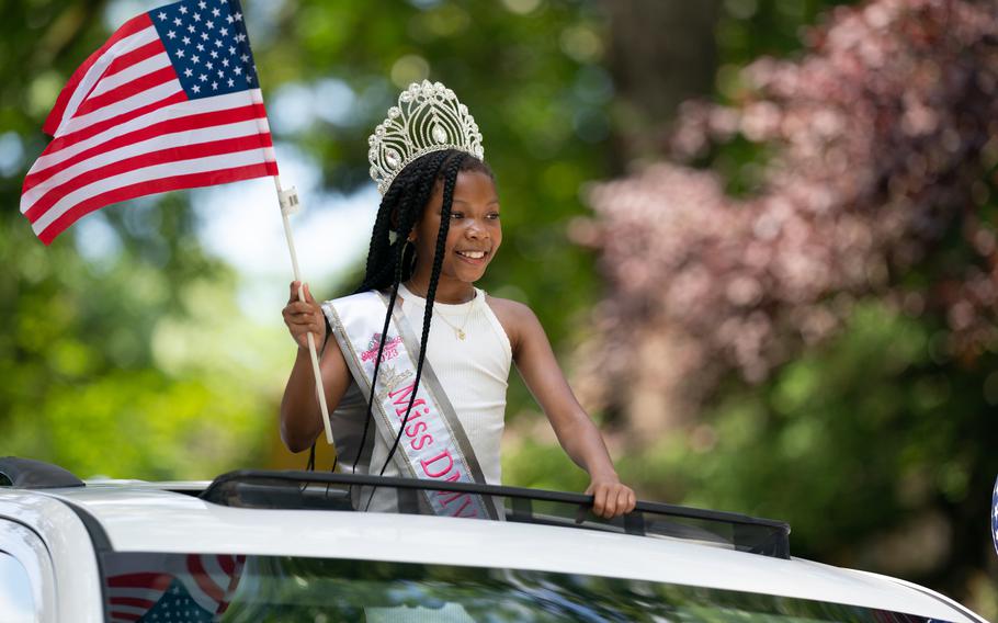 A girl representing Miss DMV Royalty waves from the roof of a car in the parade. It was the 134th Independence Day celebration for the town and Congressman Jamie Raskin was the Grand Marshall for the parade.