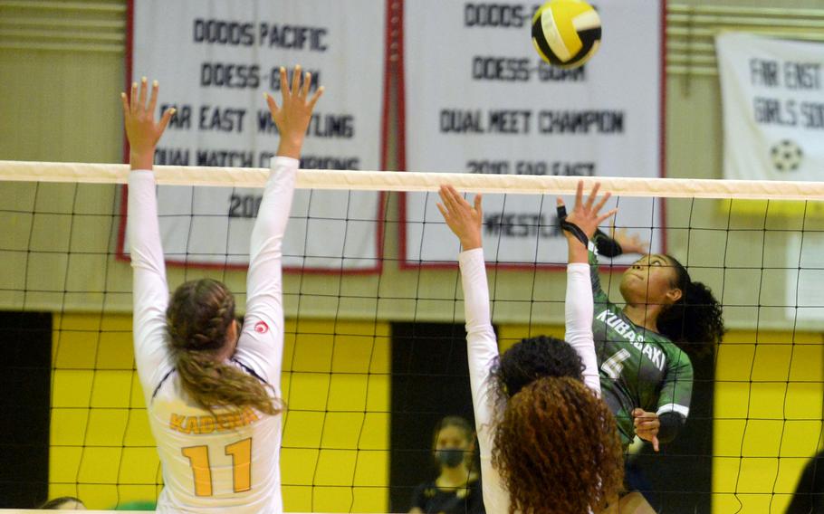 Kubasaki’s Risha McGriff spikes against the double block of Kadena’s Presley Pearce and Malea Williams during Tuesday’s Okinawa girls volleyball regular-season finale. 