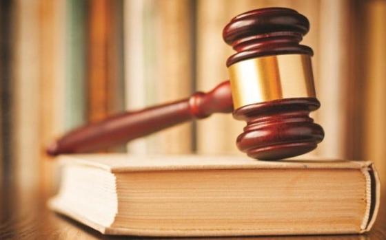 A judge's gavel rests on a book of law. Over time, the powerful have created more and more creative ways to evade detection and escape punishment.  (Dreamstime/TNS)