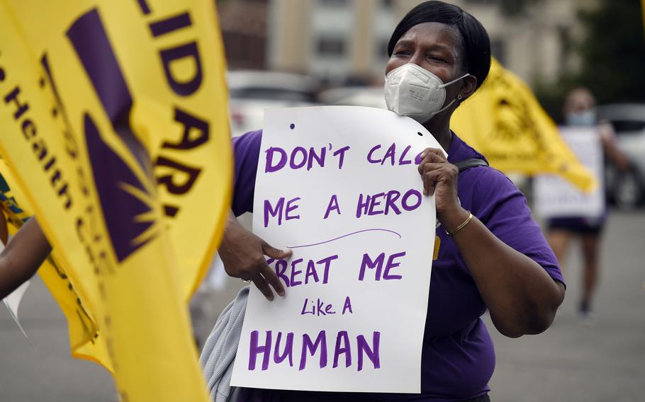 Clarissa Johnson, of Hartford, Conn., marches with long-term care members of the New England Health Care Employees Union during a rally to demand new laws to protect long-term caregivers and consumers, on July 23, 2020, in Hartford, Conn. A Connecticut program that offered “hero pay” to essential workers at the peak of the coronavirus pandemic got so many applicants that state lawmakers had to go back into session Monday, Nov. 28, 2022, to provide extra funding and put new limits on who could get the biggest bonuses. 