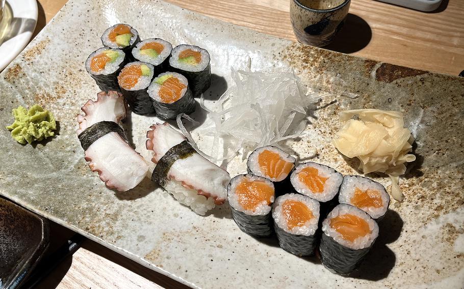 A la carte sushi orders of, counterclockwise from upper left, sake avocado maki, octopus nigiri and salmon maki. Served with the sushi are wasabi, shredded daikon radish and ginger.