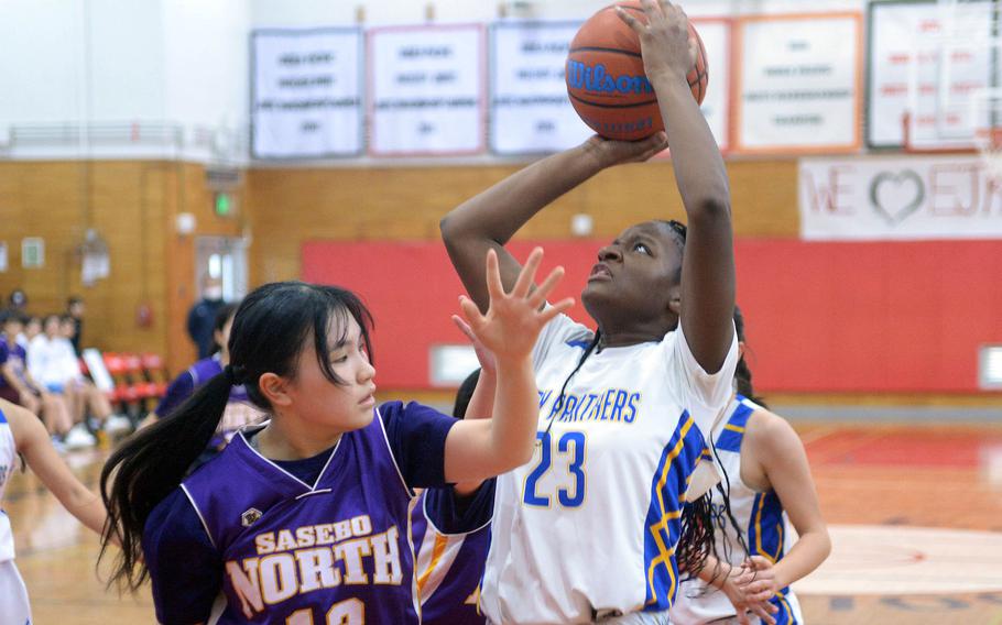 Yokota's Beverly Gardner shoots against Sasebo North's Mahiro Yoshida during Saturday's Japan girls basketball game. The Panthers won 63-48.