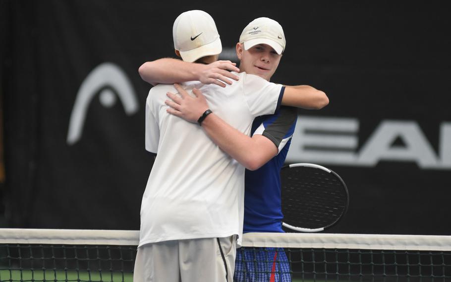 Marymount’s Leonardo Proietti (in white) and Ramstein’s Tristan Chandler hug after an epic finals in the DODEA European tennis championships on Saturday, Oct. 22, 2022, in Wiesbaden, Germany. Chandler won the singles title, 6-2, 3-6, 6-3.