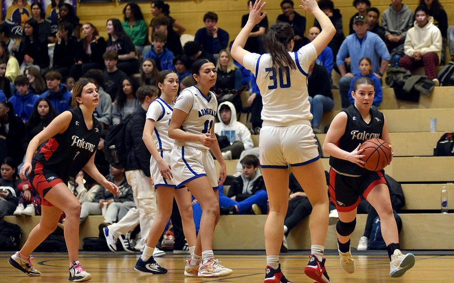 American Overseas School of Rome sophomore Silvia Goldman tries to drive around Rota senior Maidson Lewis in pool-play action of the DODEA European Basketball Championships on Feb. 15, 2024, at Wiesbaden High School in Wiesbaden, Germany.