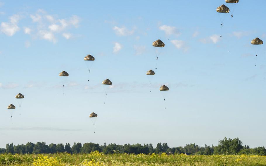 French paratroopers descend from the sky over a field in Estonia during a military exercise dubbed Operation Thunder Lynx on Wednesday June 22, 2022. 