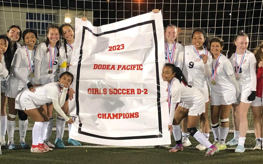 Champions at last. E.J. King's girls soccer team poses with the first Division II Tournament title banner in school history.