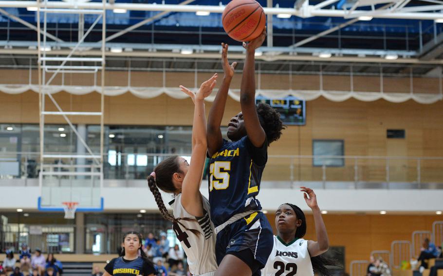 Ansbach’s Elizabeth Agudzi-Addo takes it to the hoop against AFNORTH’s Rowan Moreno in the girls Division III final at the DODEA-Europe basketball championships in Wiesbaden, Germany, Feb. 17, 2024. AFNORTH beat Ansbach 34-23.