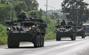 Royal Thai Army soldiers are pictured on armoured vehicles on a road in Chachoengsao province on July 24, 2025. Thailand launched air strikes on Cambodian military targets on July 24 as Cambodia fired rockets and artillery, killing at least 11 civilians, in a dramatic escalation of a long-running border row between the two neighbors. (Lillian Suwanrumpha/AFP/Getty Images/TNS)