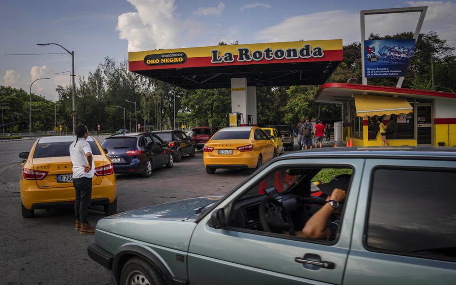 Drivers wait their turn to fuel their vehicles at a gas station in Havana, Cuba, on July 14, 2022.