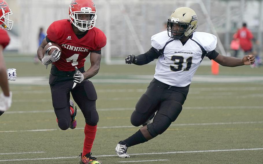 Nile C. Kinnick's Tre Bennett tries to outrun Humphreys' Jermel Wheeler Jr.