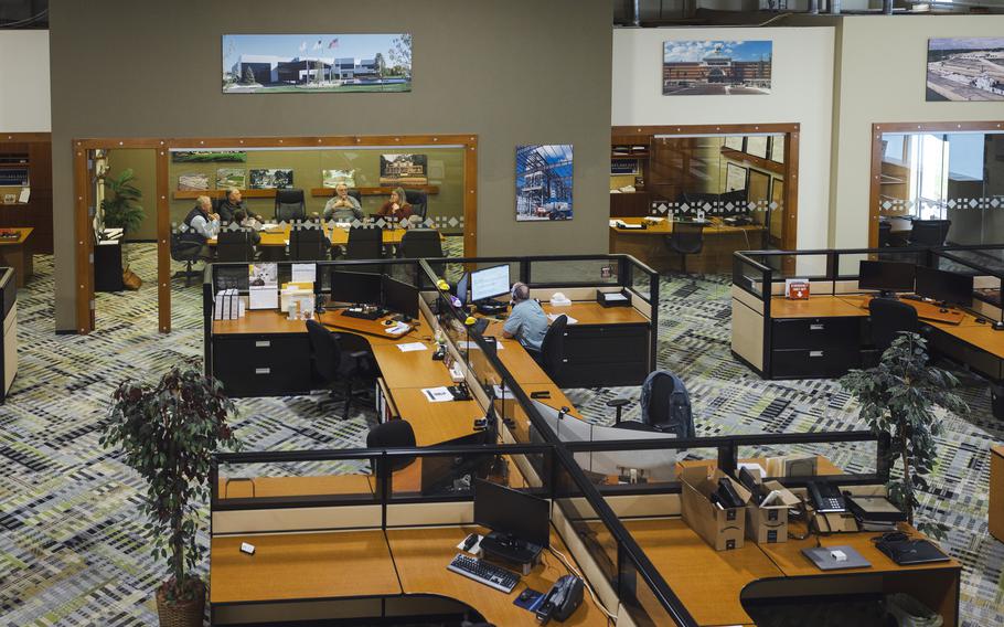 Employees work on the floor of Direct Steel and Construction offices. 