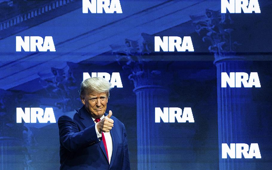 Former President Donald Trump enters to deliver remarks during the National Rifle Association annual convention at the Indiana Convention Center in Indianapolis on Friday, April 14, 2023.
