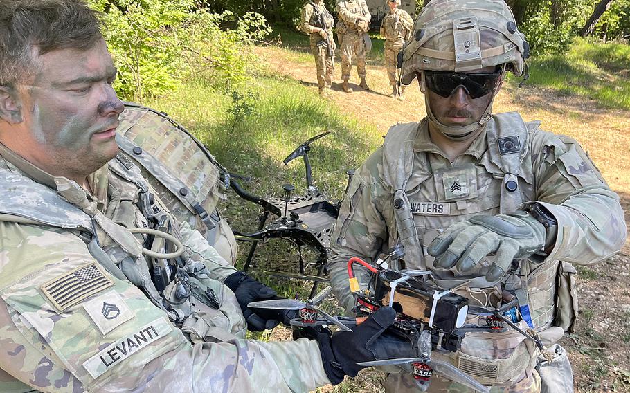 Two soldiers prepare a first-person-view drone for takeoff