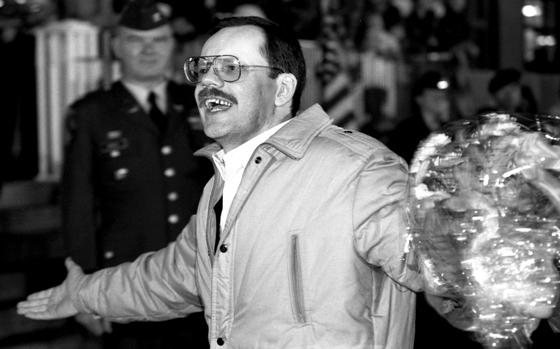 Wiesbaden, Germany, December 5, 1991:  Associated Press correspondent Terry Anderson, held captive in Lebanon for 6½ years, acknowledges the cheers of a crowd that greeted him at the Wiesbaden Air Force hospital after his release. The end of Anderson's 2,455-day ordeal was made even happier by his first meeting with his daughter, Sulome, who was born three months after his capture.