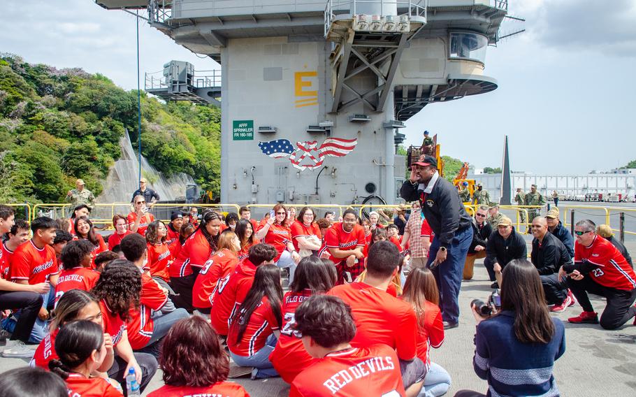 Seniors from Nile C. Kinnick High School ride an elevator aboard the aircraft carrier USS Ronald Reagan at Yokosuka Naval Base, Japan, April 18, 2023.