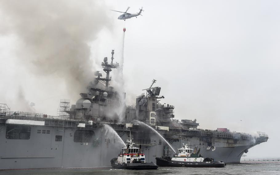 Firefighters extinguish a blaze aboard the amphibious assault ship USS Bonhomme Richard on July 13, 2020, a day after the fire broke out while the ship was moored at Naval Base San Diego. A recent Government Accountability Office study found that the Navy isn't reporting many ship fires that occur in port and doesn't have a system to learn lessons from fighting them.