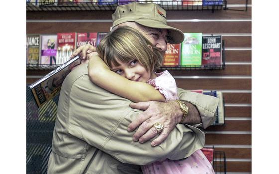 PNW10ERMEY1
Fred Zimmerman/Stars and Stripes
Jan. 8 2006
Six-year-old Emma Perry, is all smiles as she hugs "the Gunny," R. Lee Ermey, at the Camp Foster Bookmark Sunday. Emma watches Ermey's History Channel show "Mail Call" all the time and in addition to autographing her book of the same name, Ermey gave her a DVD of bloopers from the show, which he also signed.          
(pnw# 61p cm)