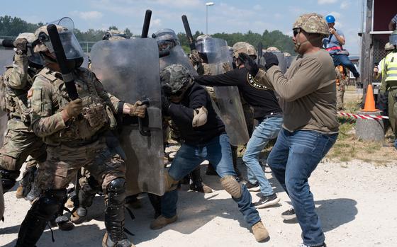 A riot is simulated during the Operation Bronze Shield training exercise June 15, 2023, at the Joint Multinational Training Center in Hohenfels, Germany. Texas National Guard troops are preparing for a mission to Kosovo, where street violence has flared up in recent weeks. 