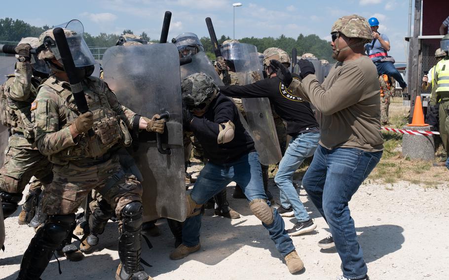 A riot is simulated during the Operation Bronze Shield training exercise June 14, 2023, at the Joint Multinational Training Center in Hohenfels, Germany. Texas National Guard troops are preparing for a mission to Kosovo, where street violence has flared up in recent weeks. 