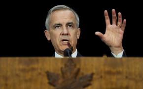 Mark Carney, at the microphone, raises his left hand while speaking at a lectern with a maple leaf emblem.