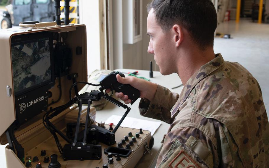 Senior Airman Shae Barnard controls the T7, a remotely operated explosive ordnance disposal robot, at Eglin Air Force Base, Fla., Aug. 25, 2022.