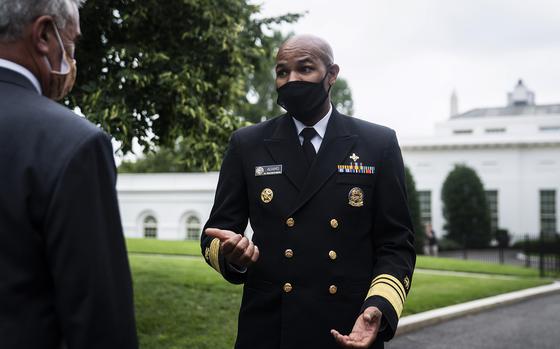 Surgeon General Jerome Adams speaks to Rep. Brad Wenstrup (R-Ohio) before an interview in 2020 at the White House. MUST CREDIT: Washington Post photo by Jabin Botsford