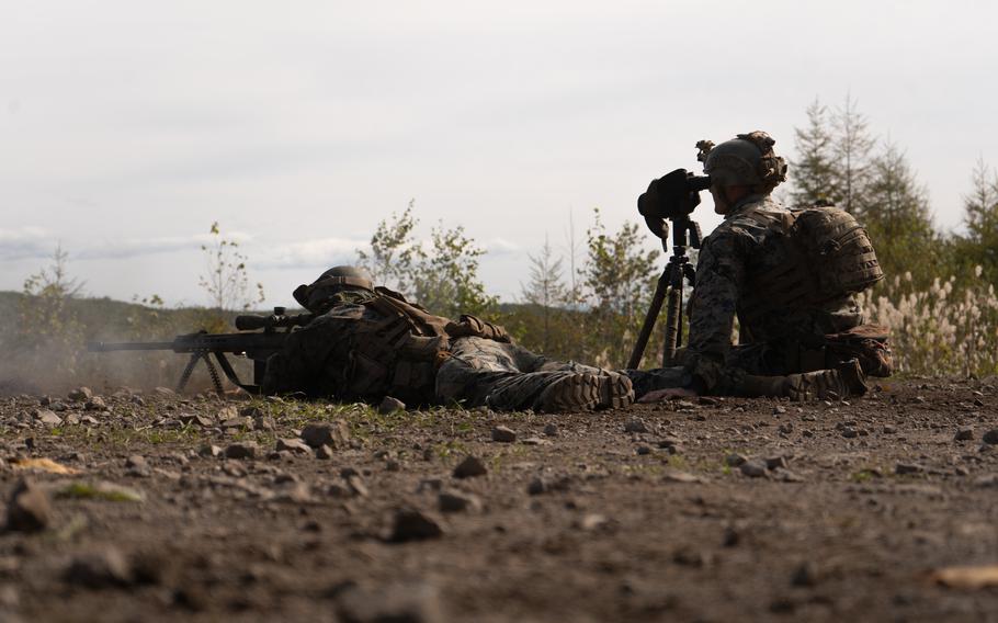 Marine Corps Sgt. Ryan Lauritsen, left, and Cpl. Jack Secrest, right, are scout snipers training at a live-fire range during Resolute Dragon 22 on Shikaribetsu Maneuver Area, Hokkaido, Japan, on Oct. 6, 2022.  