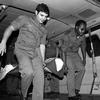 In this black and white photo, men carry a burn victim out of an ambulance.