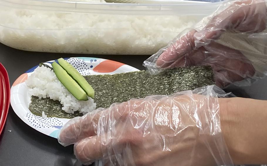 Students learn how to make temaki, cone-shaped sushi, at John O. Arnn Elementary School near Camp Zama, Japan, on Feb. 15, 2024. 