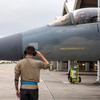 A crew chief with the 44th Aircraft Maintenance Unit salutes an F-15 Eagle pilot taxiing for a final take-off from Kadena Air Base, Okinawa, Dec. 1, 2022.