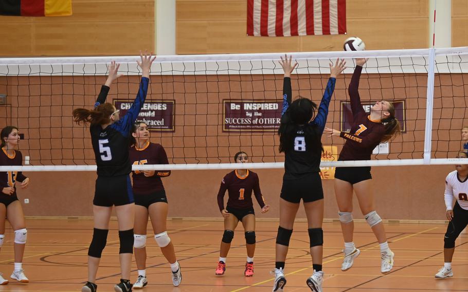 Vilseck’s Madison Bell spikes the ball towards Hohenfels’ Mananna Santos, left, and Isabel DeBorja during a scrimmage at the Vilseck High School gym on Sept. 2, 2023.