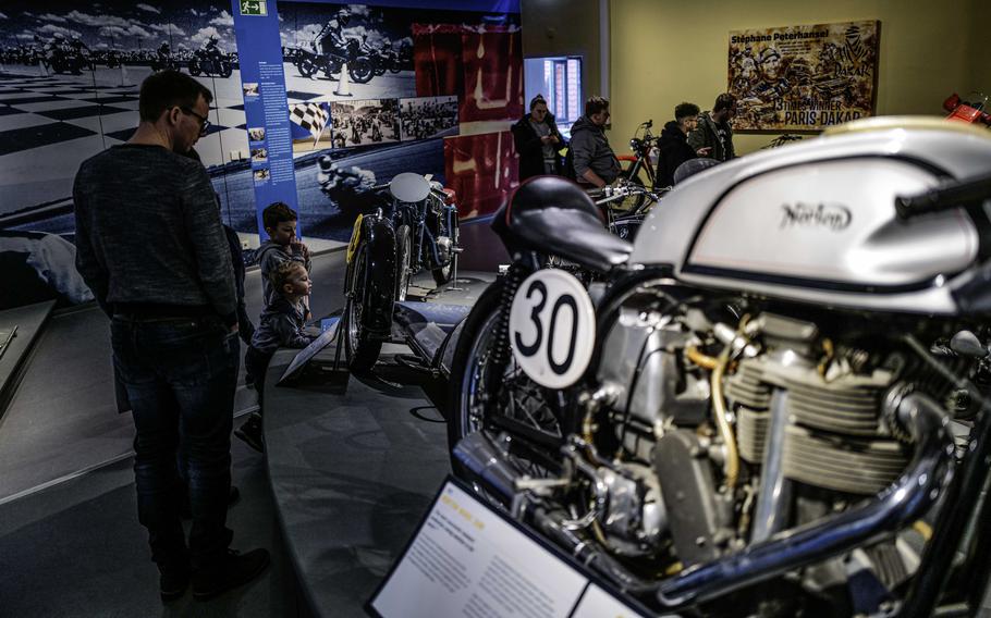 A family looks at Norton racing bikes at German Motorcycle Museum in Museum Neckarsulm, Jan. 21, 2024. The museum offers more three floors of displays ranging from the first bicycle models to modern racing machines.