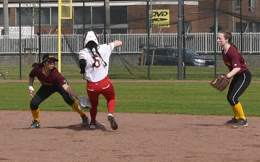 Vilseck shortstop Jayslin Santellano applies the tag as Raider senior Xin Ai Robinson attempts to steal second base on Saturday at Kaiserslautern High School in Kaiserslautern, Germany. At right is Falcon second baseman Ava Bentley.